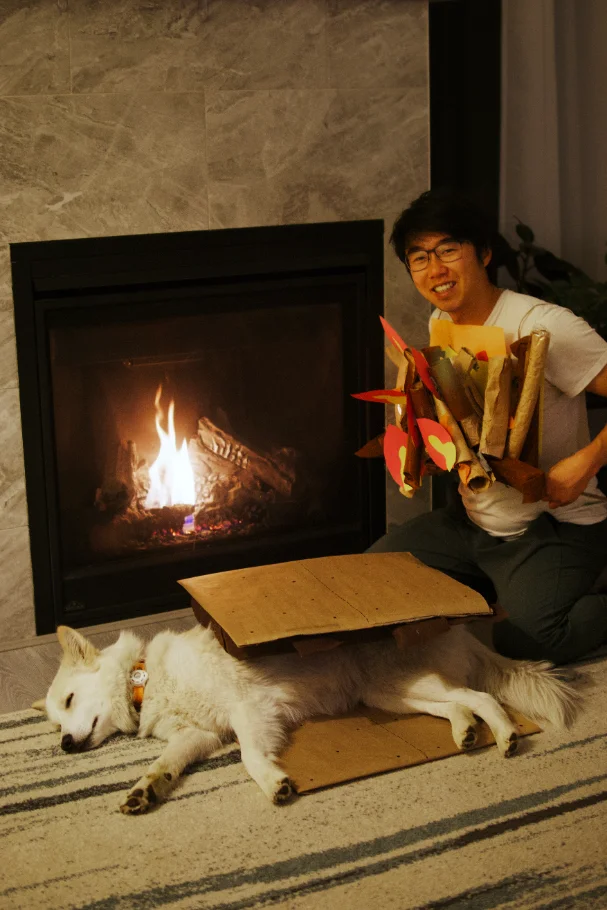 Mathew Chiang and his dog Arlo relaxing in front of a fireplace